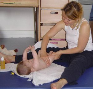 Photo d'une mère massant son bébé